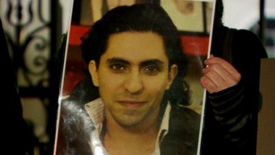 Supporter with a poster of Raif Badawi