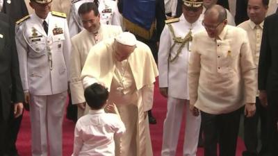 Pope Francis greets a young boy
