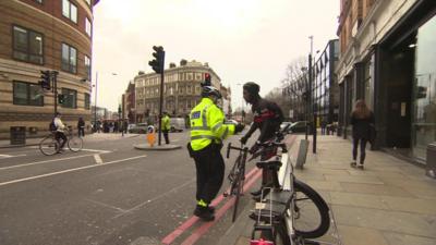 Police officer talking to cyclist