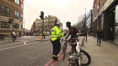 Police officer talking to cyclist