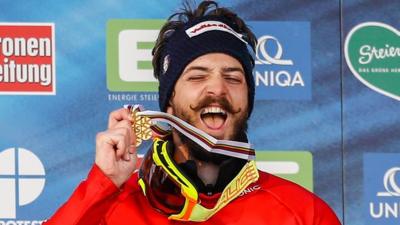 Italy's Luca Matteotti celebrates winning gold in the men's snowboard cross at the world championships in Austria