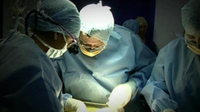 Surgeons carrying out surgical procedure