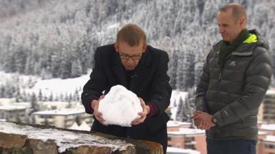Prof Hans Rosling placing a snowball on a wall to illustrate inequality
