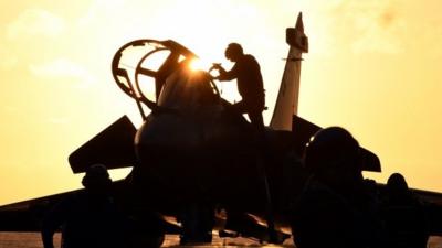 French navy soldiers prepare to fly French Rafale fighter aircraft off the aircraft carrier Charles de Gaulle at sea off the coast of Toulon, southern France, on January 13, 2015