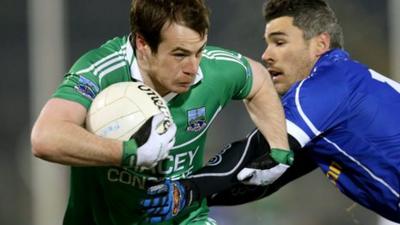 Fermanagh's Ruairi Corrigan is tackled by Cavan opponent Mark McKeever