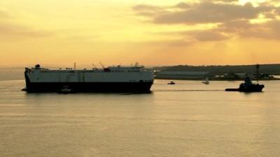 Ship being towed by a tug