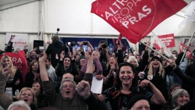 Syriza supporters celebrate as the results come in