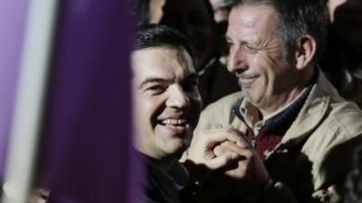 Syriza's Alexis Tsipras arrives at a party