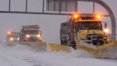 Massachusetts Department of Transportation plow crews clear the snow