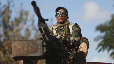 A personnel of pro-government Libyan forces, who are backed by locals, looks on during clashes in the streets with the Shura Council of Libyan Revolutionaries, an alliance of former anti-Gaddafi rebels, who have joined forces with the Islamist group Ansar al-Sharia, in Benghazi December 28, 2014