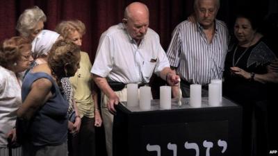 Holocaust survivors light candles at the AMIA community centre BA, 27 Jan 2015