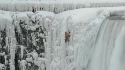 Man climbing frozen Niagara Falls