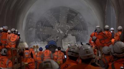 Workmen look on as tunnel machine, named Elizabeth after the Queen, to break through into the east end of Crossrail"s Liverpool Street station in London