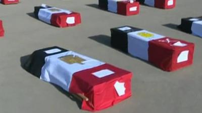 Coffins draped in Egyptian flags