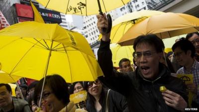 Protesters with yellow umbrellas