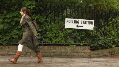 Woman walking in direction of polling station