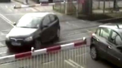 A car in the middle of a level crossing