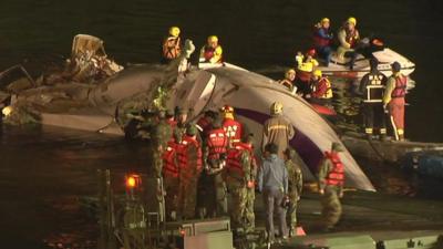 Rescue workers try to free passengers from the plane