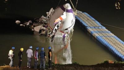 The wreckage of a TransAsia Airways turboprop ATR 72-600 aircraft is recovered from a river, in New Taipei City