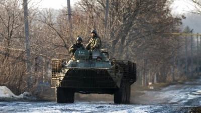 Ukrainian servicemen and armoured vehicle