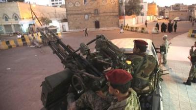 Houthi fighters in army uniform outside the presidential palace in Sanaa