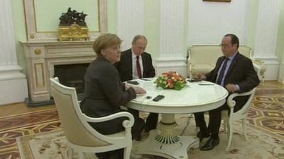 Angela Merkel, Francois Hollande and Vladimir Putin seated around a table