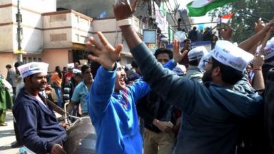 Indian Aam Aadmi Party (AAP) supporters celebrate the AAP's victory in the state assembly elections