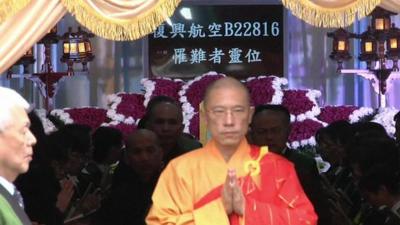 Monk leaving mass for TransAsia victims