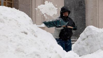 Person shovels show in Boston