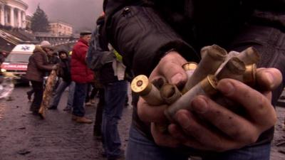 Protester in Maidan Square (Feb 2014) holds empty shell casings