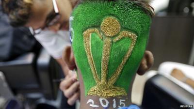 A cricket fan is pictured after having his hair trimmed into the shape of a Cricket World Cup trophy at a saloon in Mumbai, India, 12 February 2015