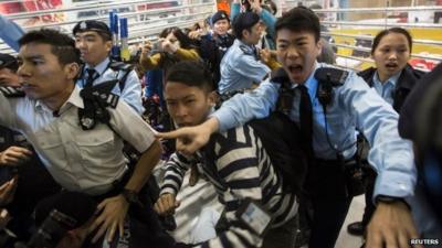 Police shout at protesters during a demonstration inside a shopping mall in Hong Kong