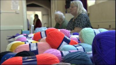 knitting thread balls next to people