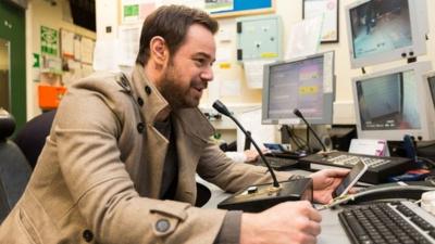 Danny Dyer speaking into a microphone