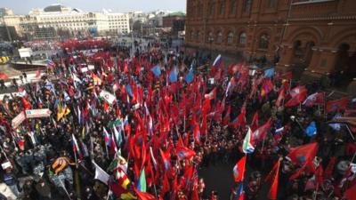 Activists from Russia’s Anti-Maidan movement gather together waving various patriotic flags in central Moscow