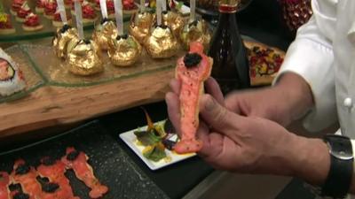 Chef Wolfgang Puck holding a smoked salmon Oscar