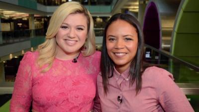 Singer Kelly Clarkson with news reporter Leah Boleto