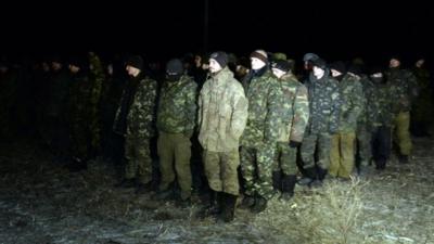 Ukrainian prisoners of war stand during a prisoner exchange with Ukraine on February 21, 2015 in the eastern Ukrainian city of Frunze near Lugansk