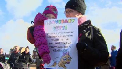 Mother and child at maternity care protest