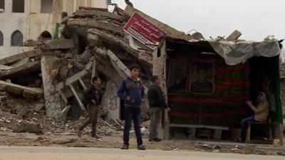 Boys standing in front of shelter in Gaza