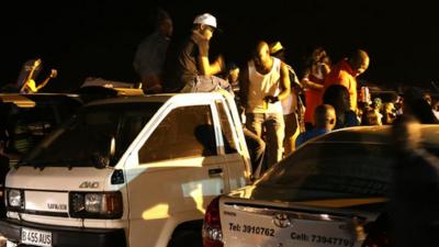 People sitting on car roof