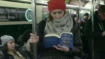 Woman reading on subway