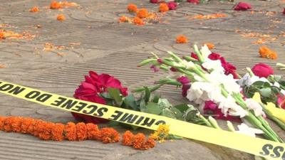 Flowers laid at sight of killing of blogger Avijit Roy with police tape saying 'Crime scene do not cross'