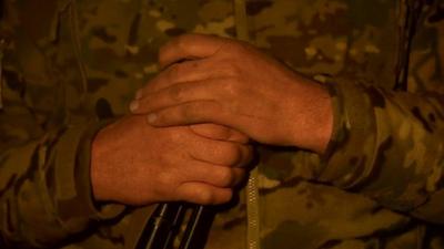 Milita man holds gun in Donetsk