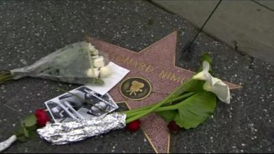 Close up of Leonard Nimoy's Hollywood star in Los Angeles with tribute flowers and photograph on it