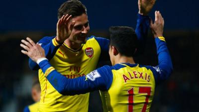 Arsenal forward Oliver Giroud celebrates with Alexis Sanchez after the Chilean scores against Queens Park Rangers