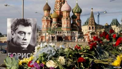 Portrait of Boris Nemtsov with floral tributes at the site where he was killed in Moscow