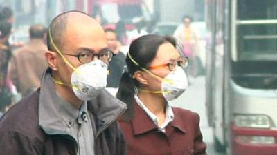 Man and woman wearing masks