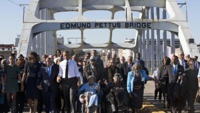 President Obama and others cross the Edmund Pettus Bridge