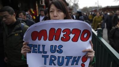 Woman holds MH370 sign in China
